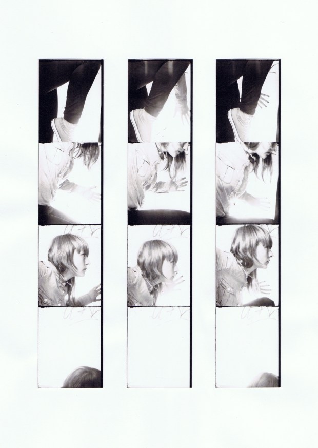 3 black and white strips of photo booth photographs where the artist performs repeated movements trying to repeat the same actions each time. 